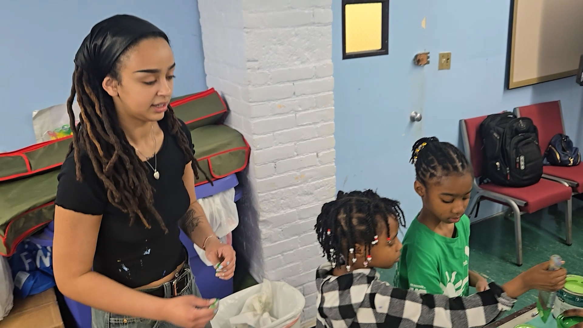 Community mentorship and young creatives engaging with production staff.
