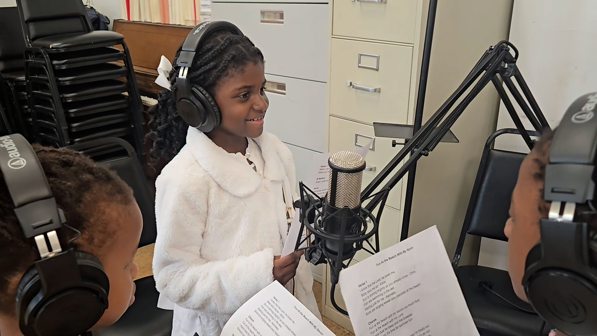 Young creative recording at a microphone during the Creative House for Young Creatives documentary.